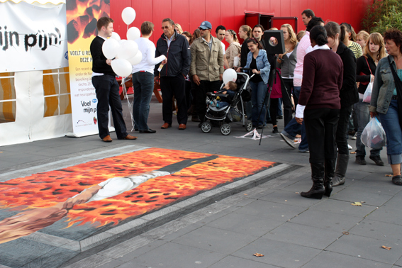 People looking at street art for Pfizer