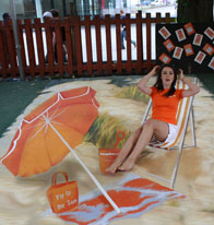 Miss Scotland posing with a 3D illusion of a beach